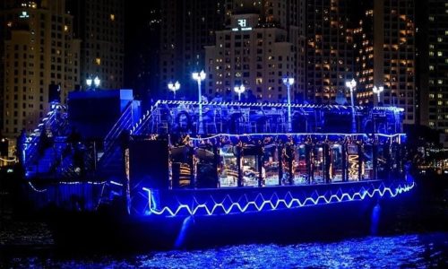 Traditional wooden Dhow cruise docked at Dubai Marina waterfront