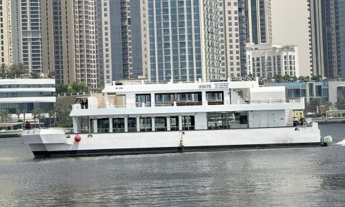 Catamaran cruise sailing through Dubai Marina during the day